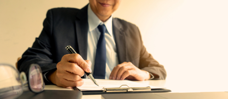 Man signing paperwork